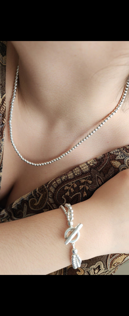 Silver beaded bracelet with open circle and silver bar