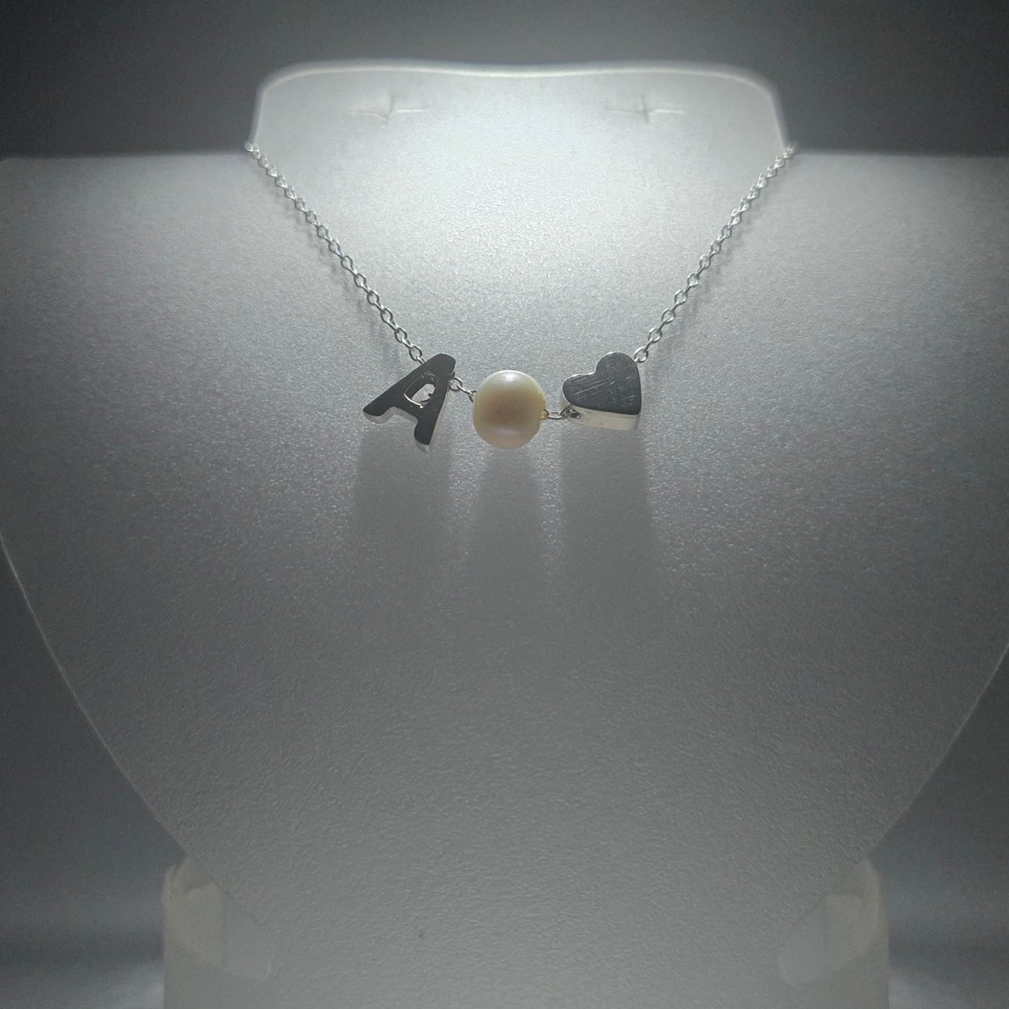 Sterling silver necklace with a pearl in between a silver heart and ANY LETTER
