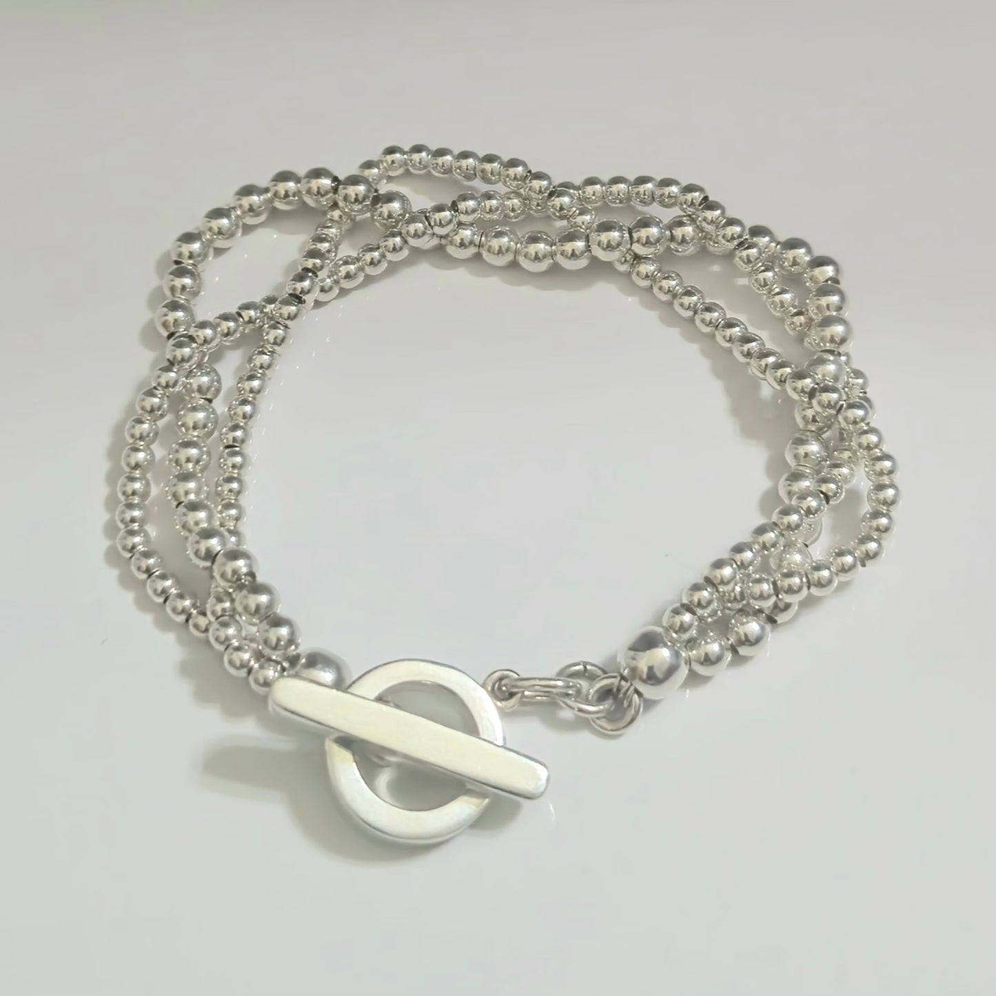 Silver beaded bracelet with open circle and silver bar