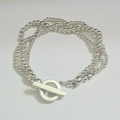 Silver beaded bracelet with open circle and silver bar