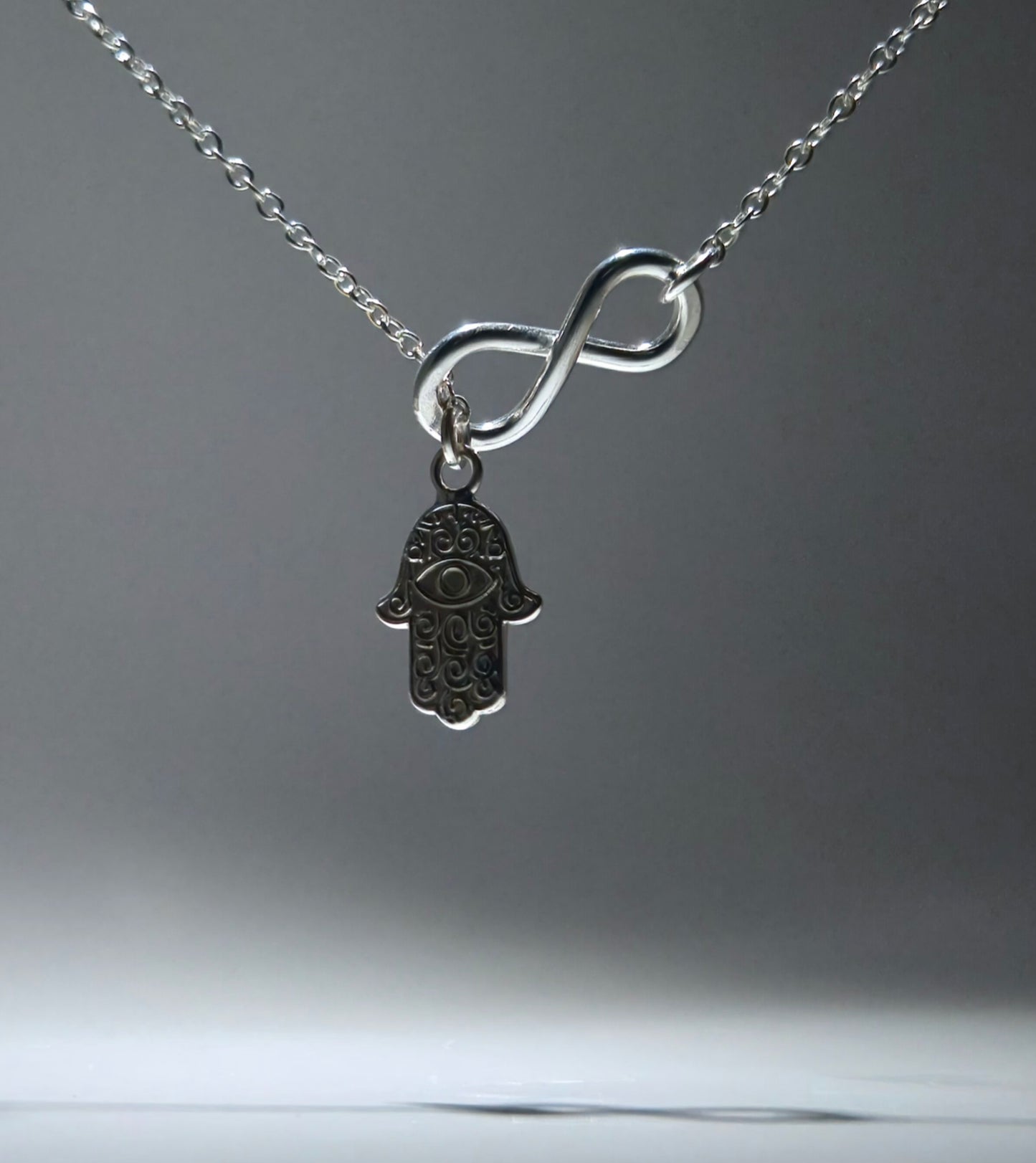 Silver Feather Pendant with infinity figure