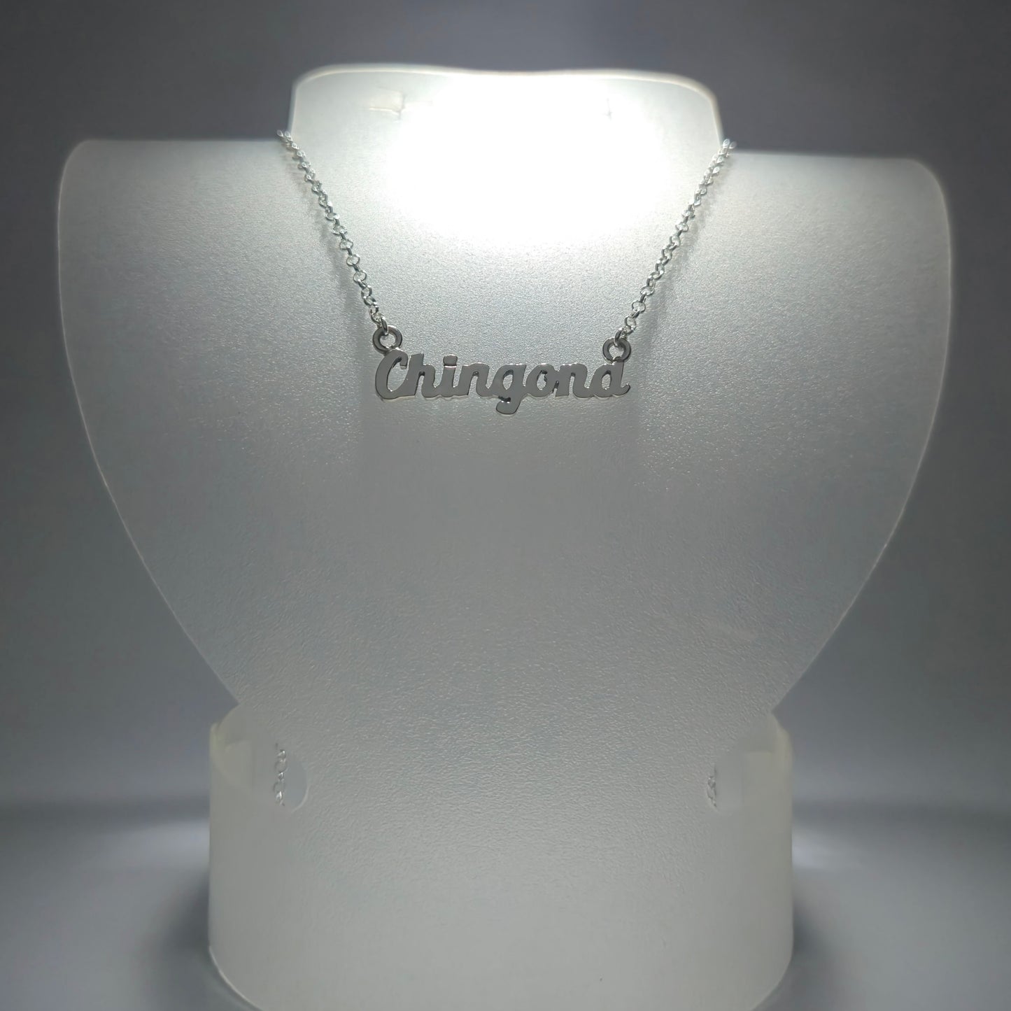 Silver chain necklace with the phrase "chingona" in silver