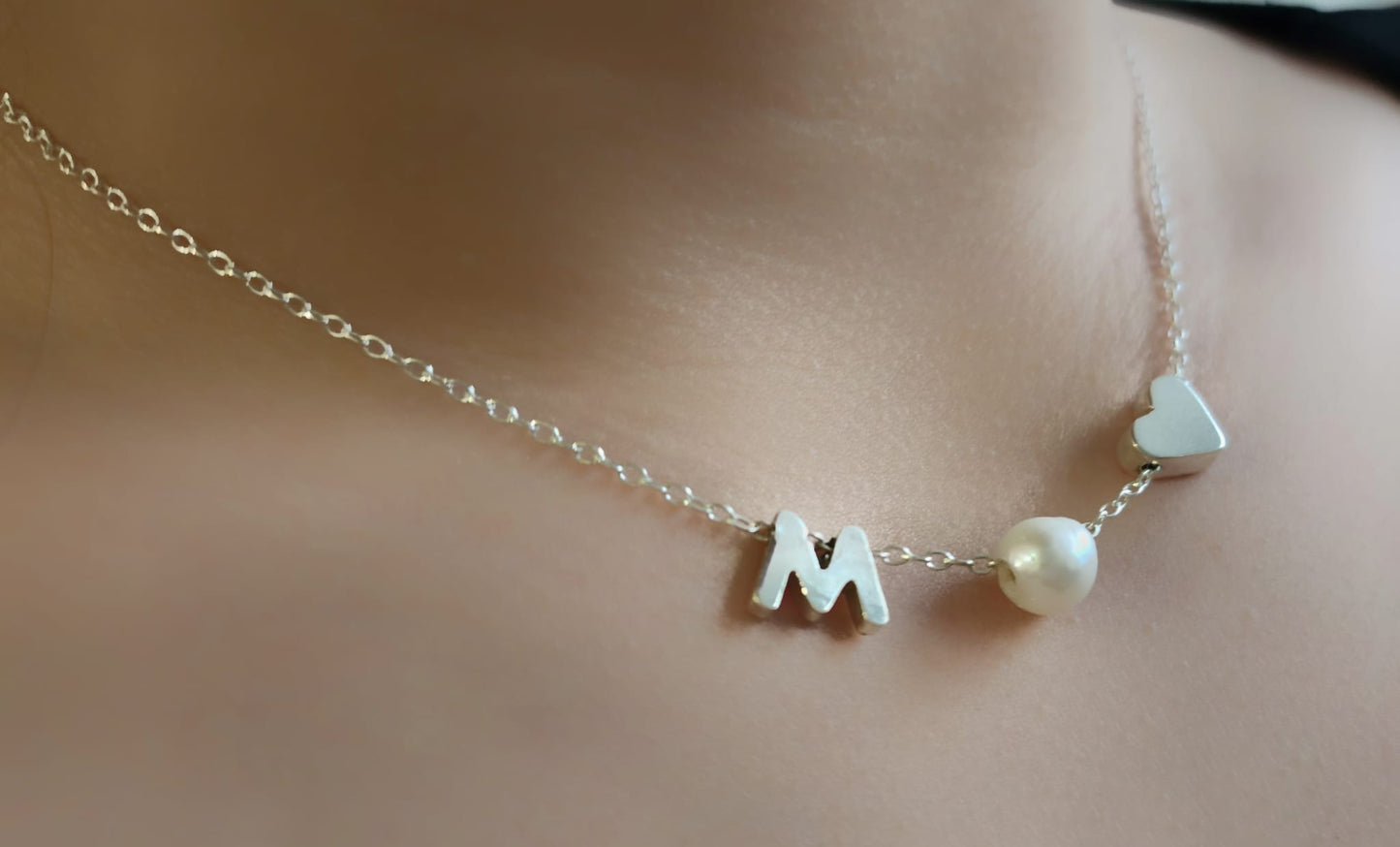 Sterling silver necklace with a pearl in between a silver heart and ANY LETTER