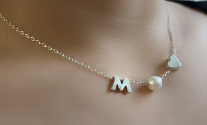 Sterling silver necklace with a pearl in between a silver heart and ANY LETTER