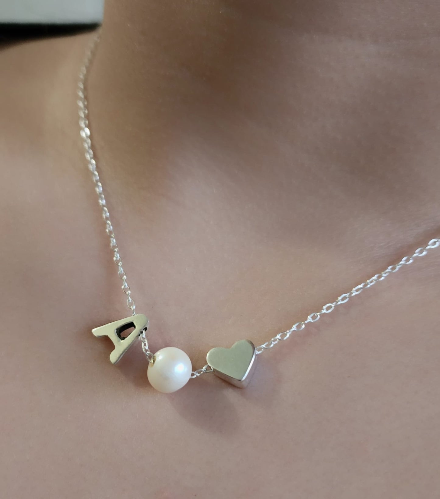 Sterling silver necklace with a pearl in between a silver heart and ANY LETTER