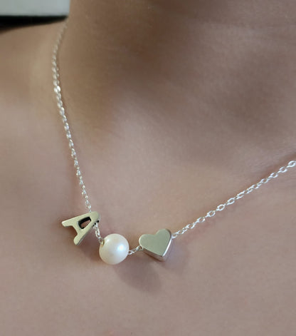 Sterling silver necklace with a pearl in between a silver heart and ANY LETTER