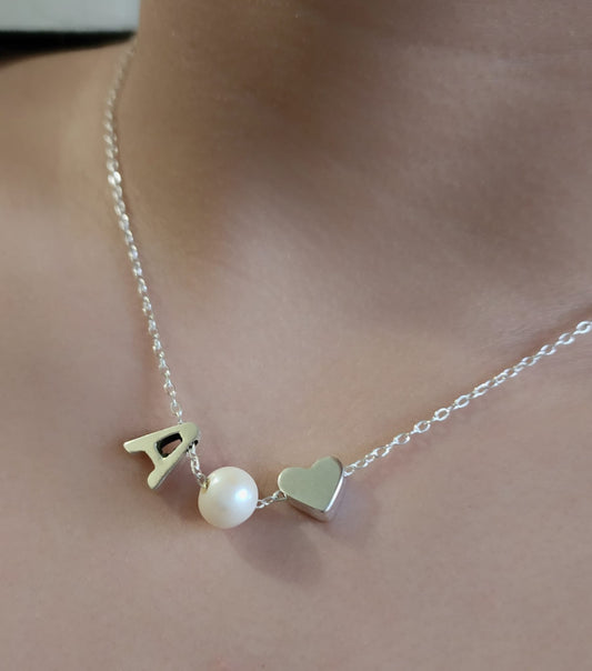 Sterling silver necklace with a pearl in between a silver heart and ANY LETTER