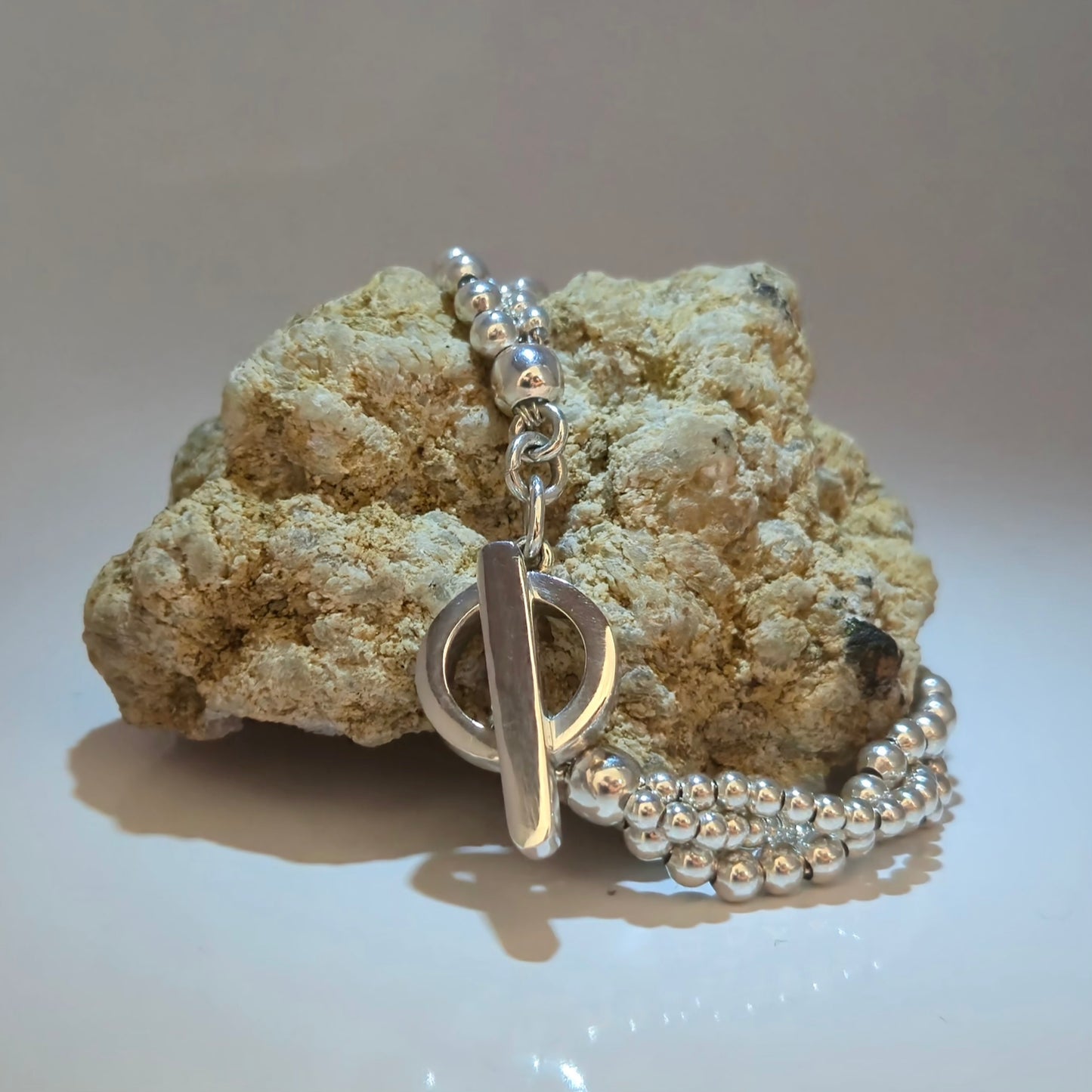 Silver beaded bracelet with open circle and silver bar